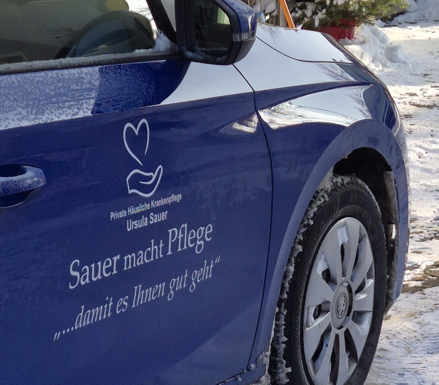 Betriebsauto vom Pflegedienst mit dem Logo und dem Text: Sauer macht Pflege ...damit es Ihnen gut geht